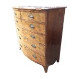 A Georgian mahogany bowfronted chest of drawers, the top above an arrangement of two short and