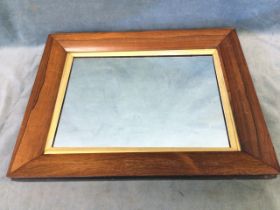 A Victorian rosewood framed mirror, the rectangular plate with gilt slip in cushion moulded
