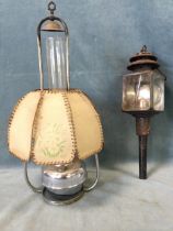 A hanging chromed oil lamp with stencilled parchment octagonal shade and tall chimney; and a