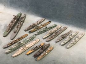 A collection of 16 cast lead waterline models of World War II warships, including destroyers,