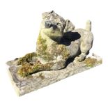 A composition stone garden figure of a recumbent Jack Rosset terrier. (17in x 7.5in x 10in)