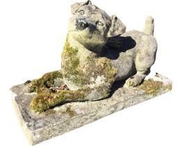 A composition stone garden figure of a recumbent Jack Rosset terrier. (17in x 7.5in x 10in)