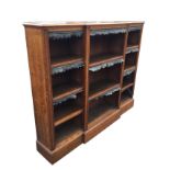 A Victorian oak breakfront open bookcase by Robson & Sons, Newcastle, the moulded top above