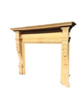 A large antique oak Georgian style chimney piece, the moulded and carved mantel supported on