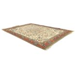 A Wilton Persian style carpet, the cream field with an allover scrolling floral and foliate design,