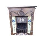 An Edwardian style art nouveau cast iron fire surround, the frieze with a sinuous pomegranate motif