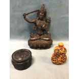 An Indian bronze seated hindu deity with a sword; a Chinese snuff bottle decorated with monkeys in