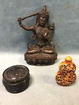 An Indian bronze seated hindu deity with a sword; a Chinese snuff bottle decorated with monkeys in