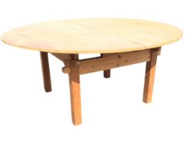 A contemporary pine rustic table, the circular folding top with piano hinge above a pegged mortice &