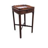 A George III mahogany urn table, the square galleried top above a frieze with slide and cast brass