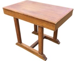 An oak centre table with panelled moulded top on rectangular supports above battens with fluted