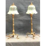 A pair of late Victorian WAS Benson arts and crafts brass pullman lamps, with turned finials above