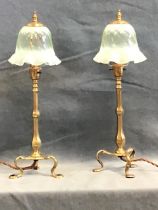 A pair of late Victorian WAS Benson arts and crafts brass pullman lamps, with turned finials above