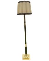 A brass standard lamp, the fluted and turned column on a square stepped base, fitted with fabric