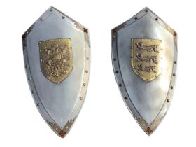 A pair of medieval style shields, with applied brass coats of arms of England and Austria
