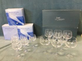 A boxed set of six Wedgwood claret glasses; and a boxed set of eight large French crystal chardonnay