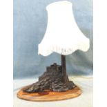 J Rynhart, a faux bronze tablelamp modelled as a lighthouse on rocky outcrop, signed and numbered,