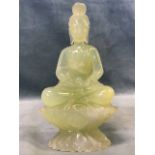 A Chinese carved pale green jade figure of a bodhisattva seated on a lotus base. (7in)