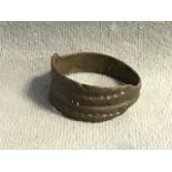 An ancient C10th - C12th Viking style ring, the ribbed band with dimpled and engraved design.