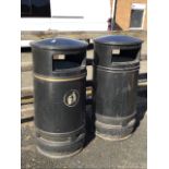 Two cylindrical litter bins with galvanised liners, the domed tops above rectangular apertures. (