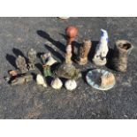A collection of small composition stone and terracotta garden ornaments including garden gnomes,