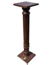 A mahogany jadiniere stand wotj square top on a turned and fluted column, the confirming base on