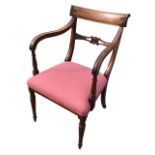 A regency mahogany armchair, the back with carved tablet crest rail and splat flanked by curved