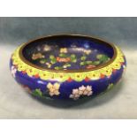 A Chinese cloisonné bowl, decorated with blossom on a deep blue ground, the underside with four