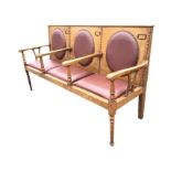 An Edwardian oak three-seater hall bench, the rectangular back with beaded mouldings and oval pads