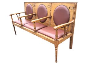 An Edwardian oak three-seater hall bench, the rectangular back with beaded mouldings and oval pads