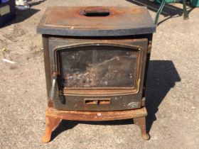 A bowfronted Tiger cast iron stove, the glazed door enclosing burning chamber above a vent, raised