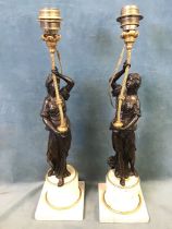 A pair of late 18th century figural candlesticks, the patinated bronze classically draped female