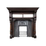 A Victorian oak chimneypiece in the Jacobean style, with cast iron insert, the gadrooned moulded