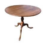 A Georgian oak and elm tilt-top table, the moulded top on a baluster turned