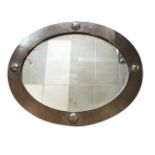 A Liberty beaten copper framed oval wall mirror, attributed to Archibald Knox, the frame with nailed
