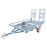 A quad bike trailer, with steel and mesh body and drop rear ramp, sprung axle, rear lights and