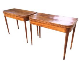 A pair of Georgian mahogany fold over top tea tables, the crossbanded and boxwood strung rounded