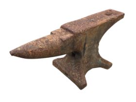 A cast iron anvil with tapering pointed nose and rectangular work platform, raised on waisted