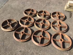 A set of ten cast iron wheels, each with moulded rims and four rectangular spokes around 3.5in