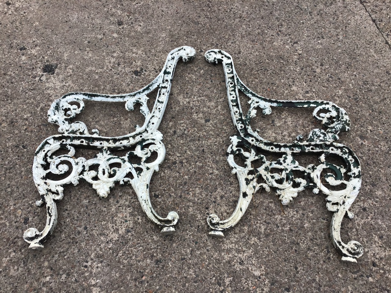 A pair of painted cast iron bench ends, the scrolled arms with lionhead terminals, raised on pierced - Image 2 of 3