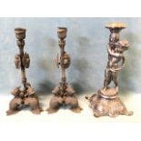 A pair of empire style candlesticks modelled with military style armour, shields and helmets
