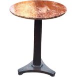 A mahogany occasional table, the circular top on a tapering hexagonal column, the tripartite base on