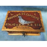 A World War II carved and painted wood box made by a French prisoner of war in Stalag III B,