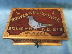 A World War II carved and painted wood box made by a French prisoner of war in Stalag III B,