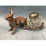 A Victorian Bergman style cold painted metal hare inkwell with metal mounted glass ink bottle. (