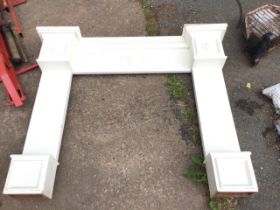 A painted chimneypiece with breakfront mantlepiece above dentil moulding and panelled frieze with