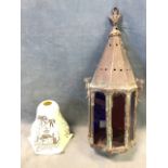 An octagonal eastern brass hanging lantern, the conical top above coloured glass panels - 18.5in