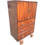 An art deco walnut cabinet with cupboard above three drawers, all mounted with tubular chrome