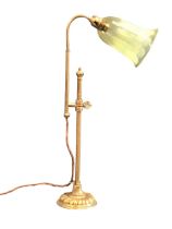 A brass arts and crafts style reading lamp, the mouth blown ribbed bell form vaseline glass shade on