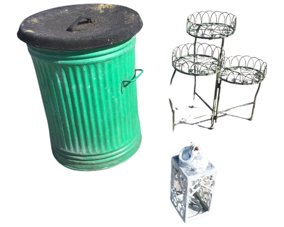 A green painted galvanised bin with rubber cover; a three-tier wirework plant stand; and a